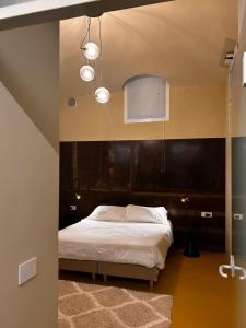 a bedroom with a large bed with a black headboard at Villa Sardino in Settimo Vittone