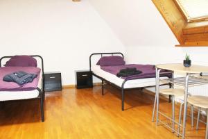 a room with two bunk beds and a table at Fully equipped Apartments in Bönnigheim