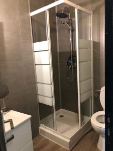 a shower with a glass door in a bathroom at Charmant T2 centre ville in Givet +27 photos
