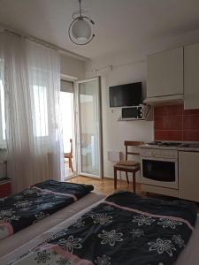 a hotel room with two beds and a kitchen at Apartments Tepić in Banja Luka