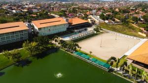 an aerial view of a city with a pool of green water at Villa Hípica Resort in Gravatá