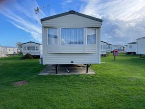 a tiny house on a stand in a yard at 8 Berth family caravan Selsey West Sussex in Selsey