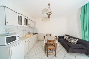 a kitchen and living room with a couch and a table at Apartmani Katica in Kornić +14 photos