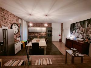 a kitchen and dining room with a table and a refrigerator at MC FLY ROOMS Malpensa airport in Gallarate