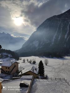 a view of a snow covered valley with a mountain at Appartamento centro Brusson. in Brusson