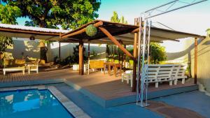 a deck with a table and chairs next to a pool at Lamamie guest house in Thohoyandou