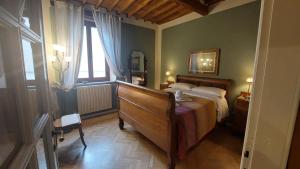a bedroom with a large bed and a window at Residenza San Giorgio in Lucca