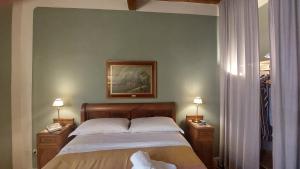 a bedroom with a bed and two night stands with lamps at Residenza San Giorgio in Lucca