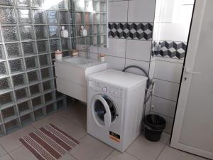 a laundry room with a washing machine and a sink at VILLA MARIE in Marigot +4 photos