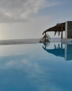 a swimming pool with the ocean in the background at Las Fragatas Casa Hotel in Canoas de Punta Sal