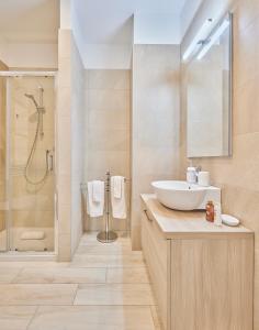 a bathroom with a sink and a shower at Monviso Mono - Exclusive Apartment in Milan