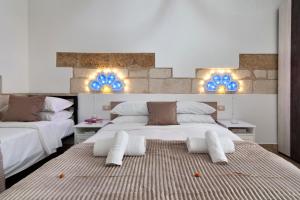 a bedroom with two beds and blue lights on the wall at Il Cortile dei Cantori in Lecce