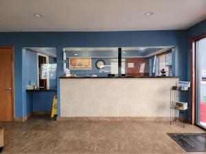 a kitchen with blue walls and a counter top at Texas Inn and Suites Raymondville in Raymondville