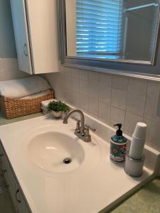 a bathroom counter with a sink and a mirror at George's B&B in Lewiston