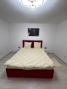 a large bed in a white room with a white bedspread at Crang Luxury View in Buzău