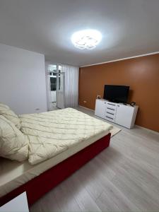a bedroom with a bed and a flat screen tv at Crang Luxury View in Buzău