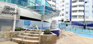 a staircase in front of a building with a swimming pool at Rio Quente GO Apto 7 Pessoas 2 Qtos in Rio Quente