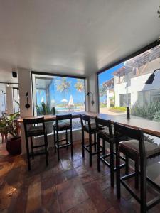 - une salle à manger avec une table et des chaises et une vue sur l'océan dans l'établissement Pousada Caravelas de Pinzón, à Cabo de Santo Agostinho