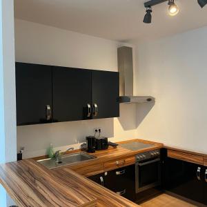 a kitchen with a sink and a stove at VIKTORIA RESIDENCE in Saarbrücken