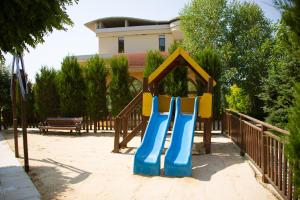 a playground with a slide in a park at Apart Hotel Apolonia Palace in Sinemorets
