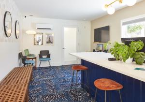 a kitchen with a blue and white counter and stools at Little Mod in Charlottesville