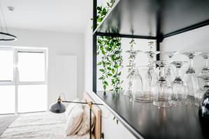 a group of clear glass vases sitting on a counter at Chaplin Apartment in Poznań