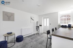 a large white room with a table and chairs at Bright 2bed Apartment in Worksop in Worksop