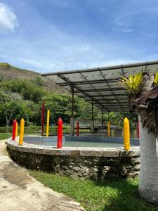 a group of red and yellow barriers in front of a building at Pesque pague pousada do Carlinho in Pinheiral