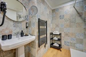 a bathroom with a sink and a mirror at Boutique Hôtel Provencia in Marseille +35 photos