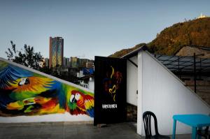 a building with two paintings on the side of it at Hostal Chorro De Quevedo in Bogotá