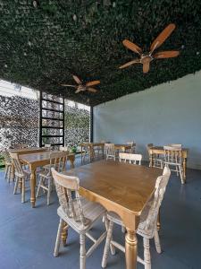 une salle à manger avec des tables, des chaises et des ventilateurs de plafond dans l'établissement Malik Hotel Boutique, à Cali