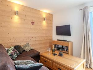een woonkamer met een bank en een flatscreen-tv bij Appartement Morzine, 4 pièces, 6 personnes - FR-1-754-23 in Morzine