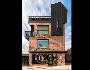 a brick building with a black box on top at The Brick Boutique Hotel in Oceanside