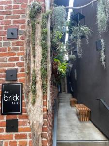 an alley with potted plants on the side of a building at The Brick Boutique Hotel in Oceanside