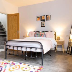 a bedroom with a bed in a room with a staircase at Cambridge Mews - Central Hebden Bridge in Hebden Bridge