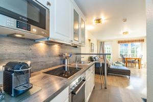 a kitchen with a sink and a living room at Altstadttor 5 in Westerland +11 photos