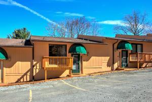 a building with a parking lot in front of it at Cedar Village Condominiums in Beech Mountain