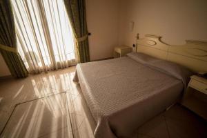 Cama ou camas em um quarto em Sa Rocca Sport e Resort
