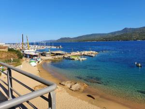 a view of a beach with boats in the water at Appartement T2 terrasse vue mer à 180 in Propriano
