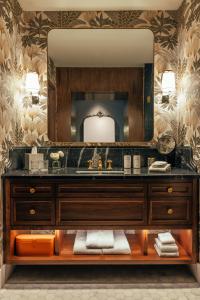 a bathroom with a sink and a mirror at The Global Ambassador in Phoenix