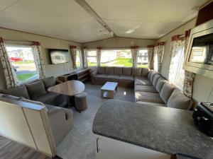 a living room with a couch and a table at 87 Lancaster Crescent in Tattershall