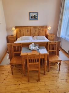 a bedroom with a table with chairs and a bed at Penzion Bazalka in Jablonec nad Nisou