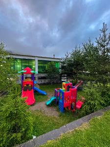 a playground with two play equipment in a yard at Bakuriani Crystal Loft in Bakuriani