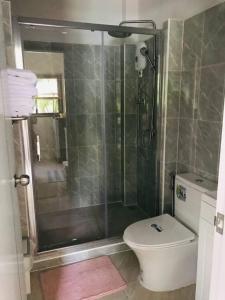 a bathroom with a shower and a toilet at Summer House,shared pool, private bathroom and kitchen in Ban Phlu Yai +27 photos