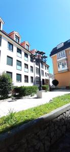 a large white building with a statue in front of it at Twin Room in shared Apartment in Cee