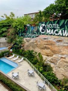 a resort with a swimming pool and a hotel on a cliff at Hotel Macaw Cúcuta in Cúcuta