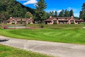a golf course in front of a large house at Golf and Mountain Jewel Bug Condo in North Woodstock