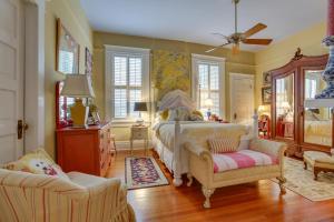 a bedroom with a bed and two chairs at Private Pool and Backyard Lavish New Orleans Haven! in New Orleans +29 photos