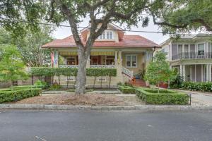 a yellow house with a tree in front of it at Private Pool and Backyard Lavish New Orleans Haven! in New Orleans