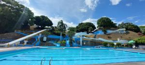 a large swimming pool with a water slide at Hotel y Parque Acuatico Agua Sol Alegria in Honda